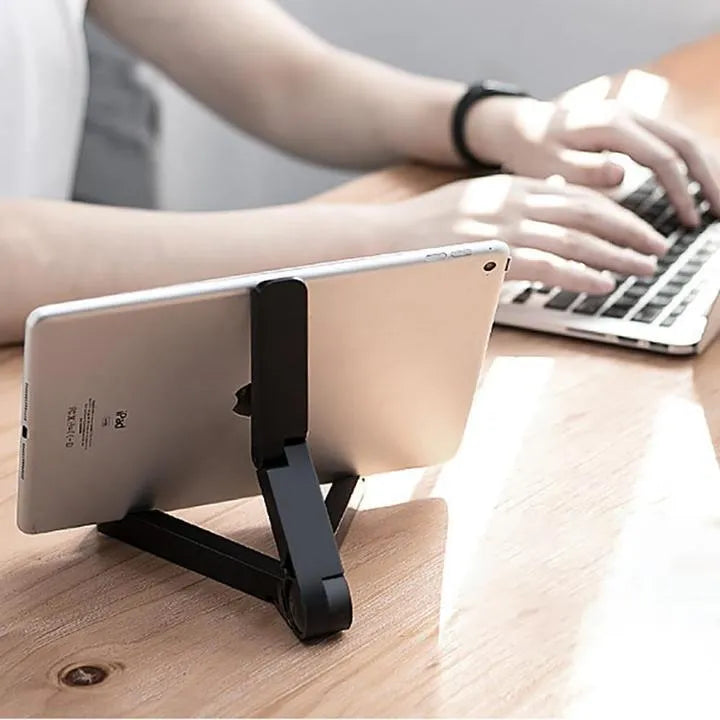 Black foldable tablet holder standing upright with a tablet in landscape mode on a desk