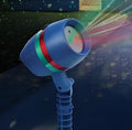 Mini LED projection lamp on lawn casting starry sky laser light pattern at night