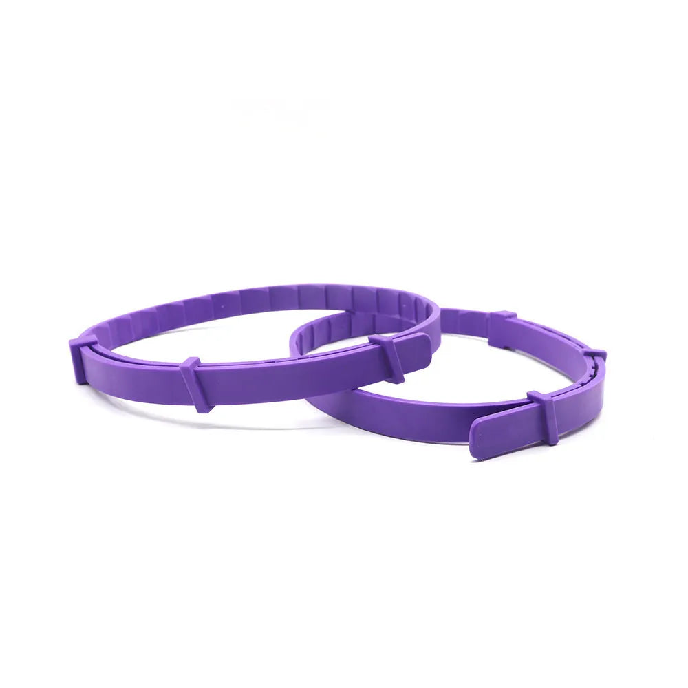 Pack of four dog anxiety relief collars in TPR, showing black, blue, grey, orange, pink, and purple monochrome dog patterns.