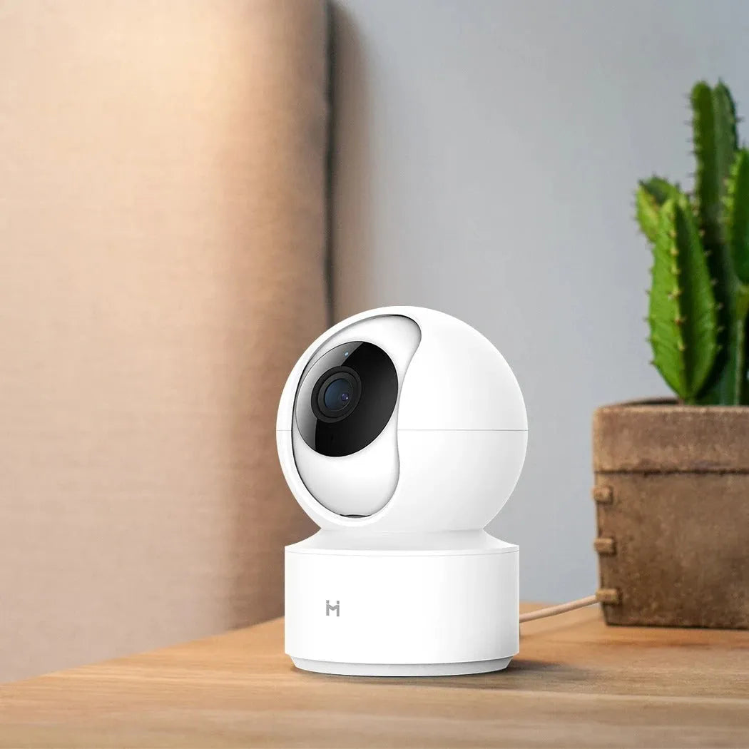 White Xiaobai smart security camera on a surface showing its compact design.