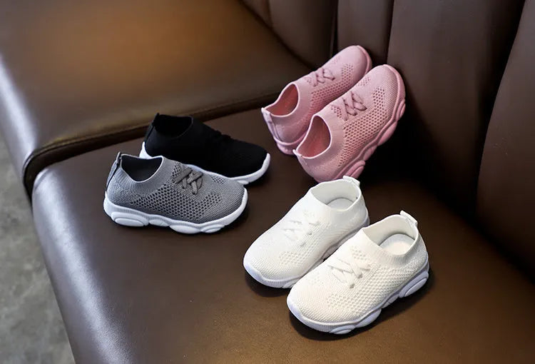 Children's white lazy slip-on shoe with fabric upper and textured non-slip rubber sole.