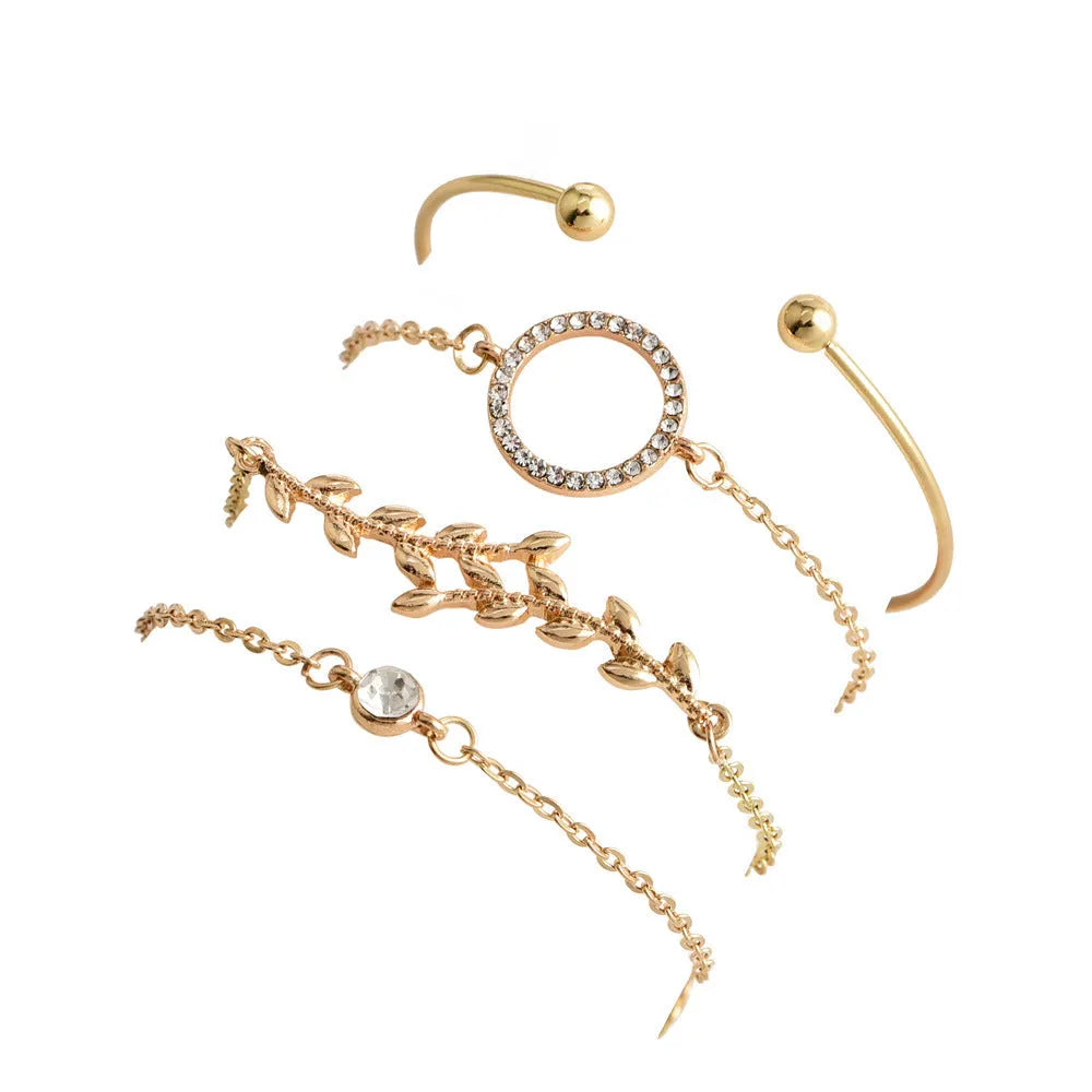 Gold alloy geometric bangle combination set with electroplated finish and about 16cm diameter