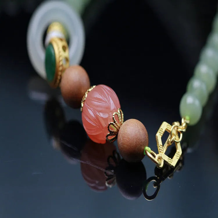 Hetian jade lotus bead necklace with white sandalwood beeswax pendant and fu character charm