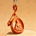 Eight patron saint keychains made of natural Taomu wood in orange colour, each measuring 10x3.2x4cm