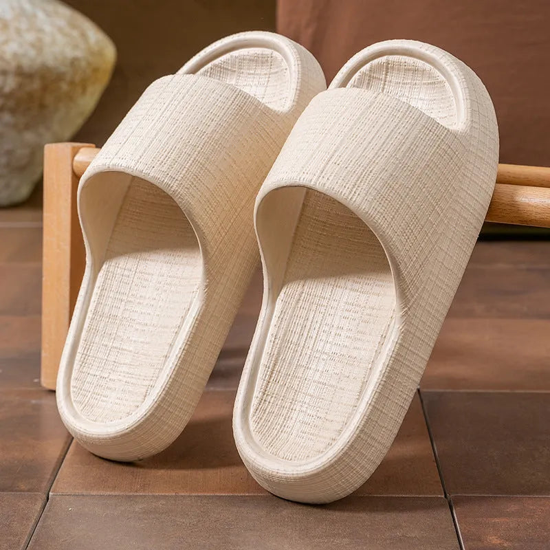 Women's soft EVA non-slip bath slipper in black, showing toe ring flip-flop design and textured sole.