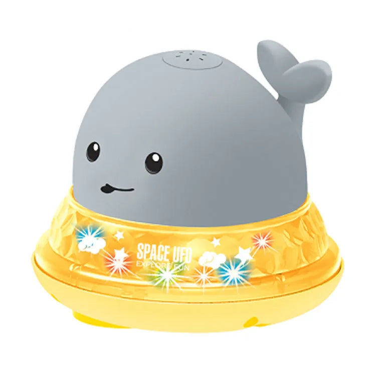 Grey and white cartoon whale bath toy floating in water with spray fountain and LED lights