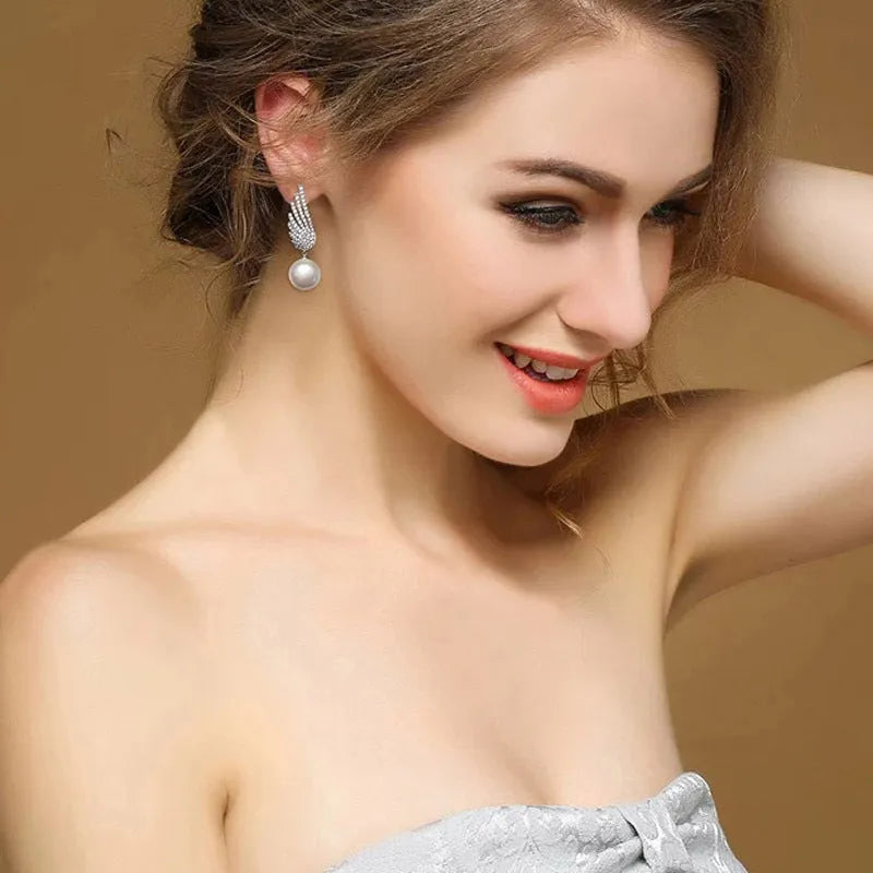 Silver angel wing earrings with diamond-treated metal and gold-plated inlaid gemstones in platinum colour