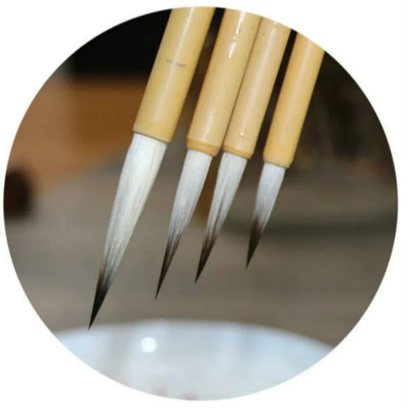 Four Chinese calligraphy brushes with mixed wolf wool and goat hair bristles on gold lacquer wooden bodies