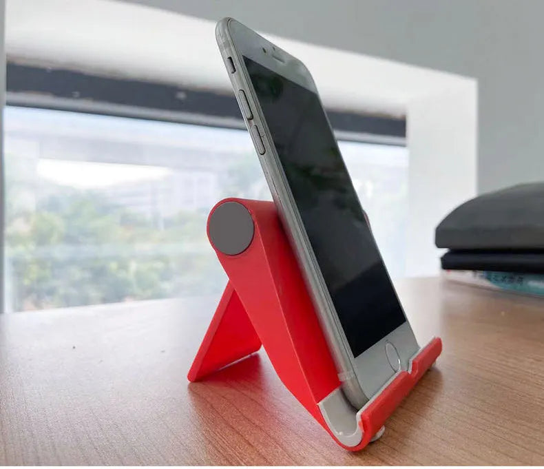 PE folding tablet and mobile phone stand in an adjustable open position on a desktop.