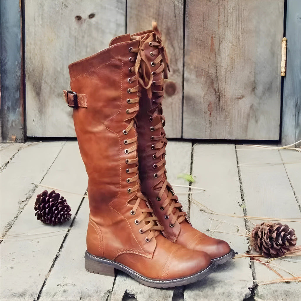 Black chunky heel high-leg casual boot with round toe and low rubber sole on a plain background.