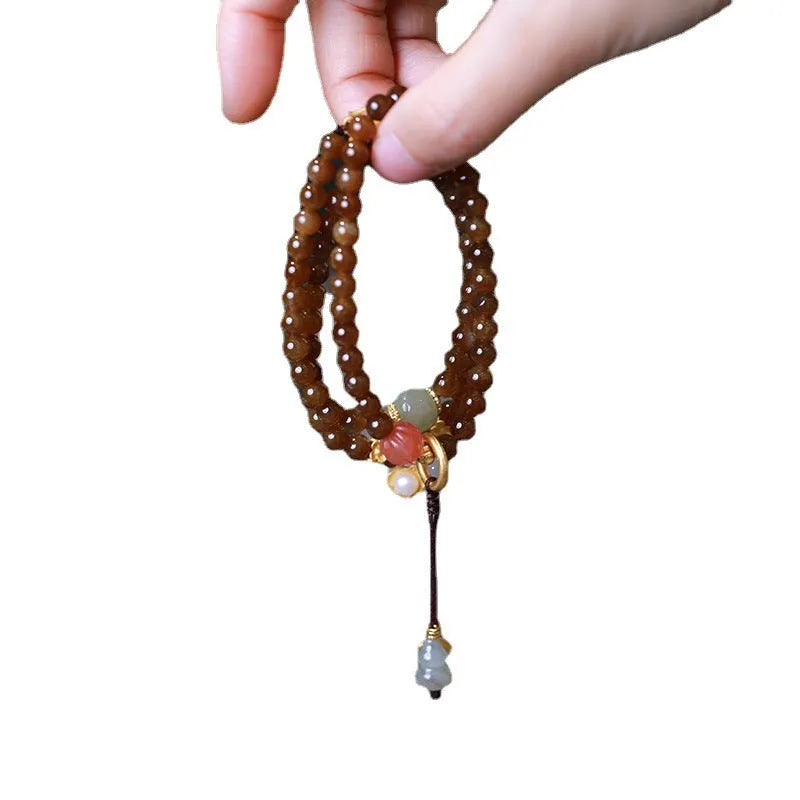 Brown jade Hetian jade women's bracelet with silver accents in a geometric three-ring design.