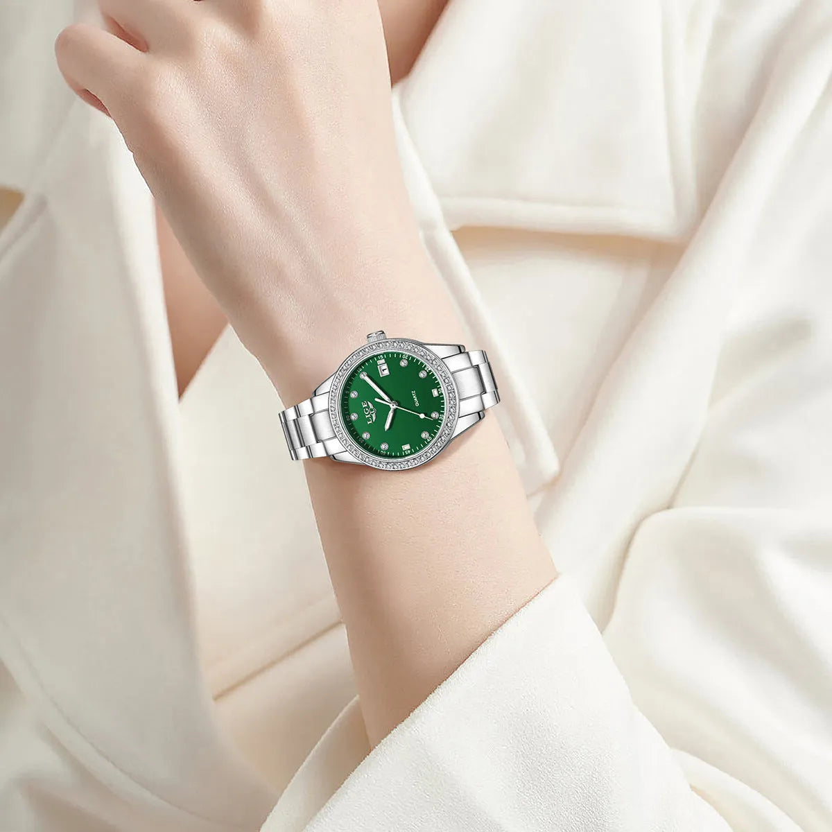 Women's silver stainless steel watch with diamond bezel and luminous hands on a 34mm round dial.