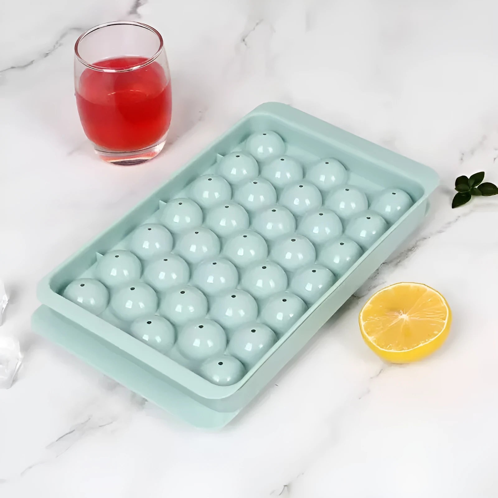 Blue silicone ice cube tray with lid showing 33 round cavities for large ice.