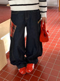 Man wearing loose straight-leg casual trousers in a red plaid pattern.