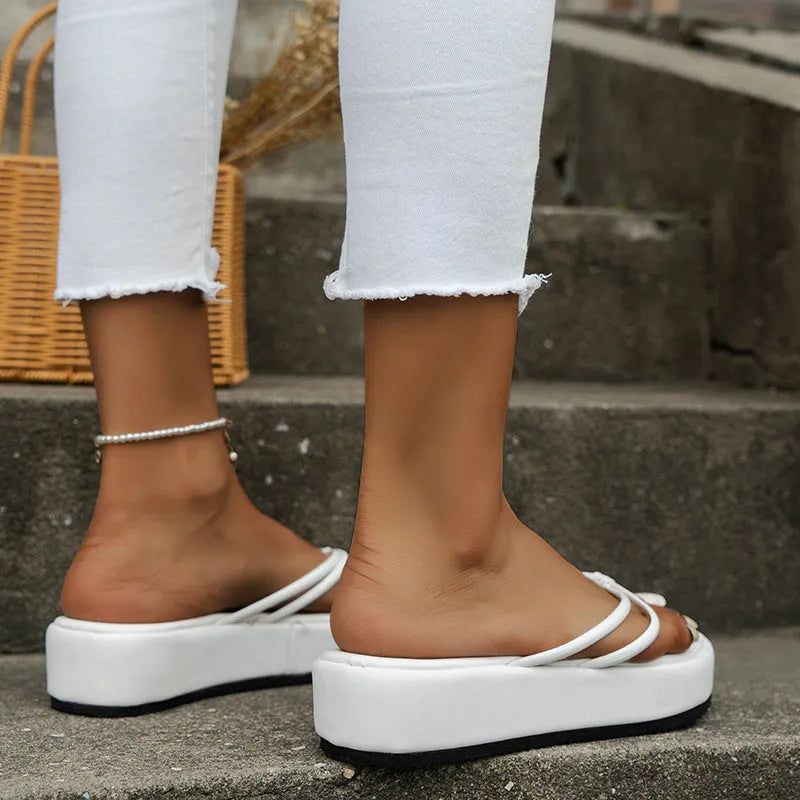 Pair of thick-soled herringbone style flip-flops on a plain background, shown in one of the six available colours.