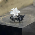 Bipolar Disorder French Simplicity copper ring in white and black with lily motif on neutral background