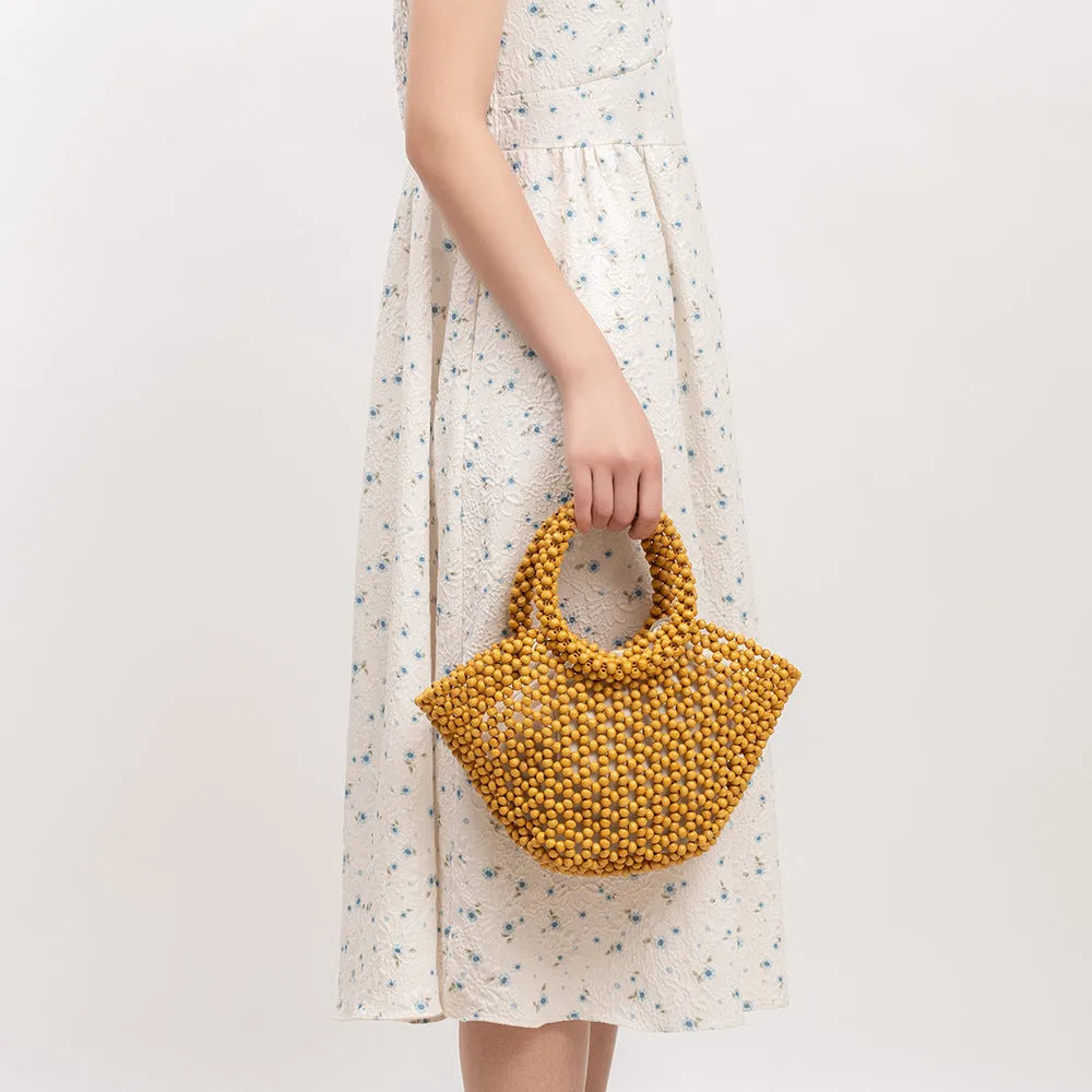 Hand-woven maple beach bag with wooden bead decoration showing hollow dumpling design