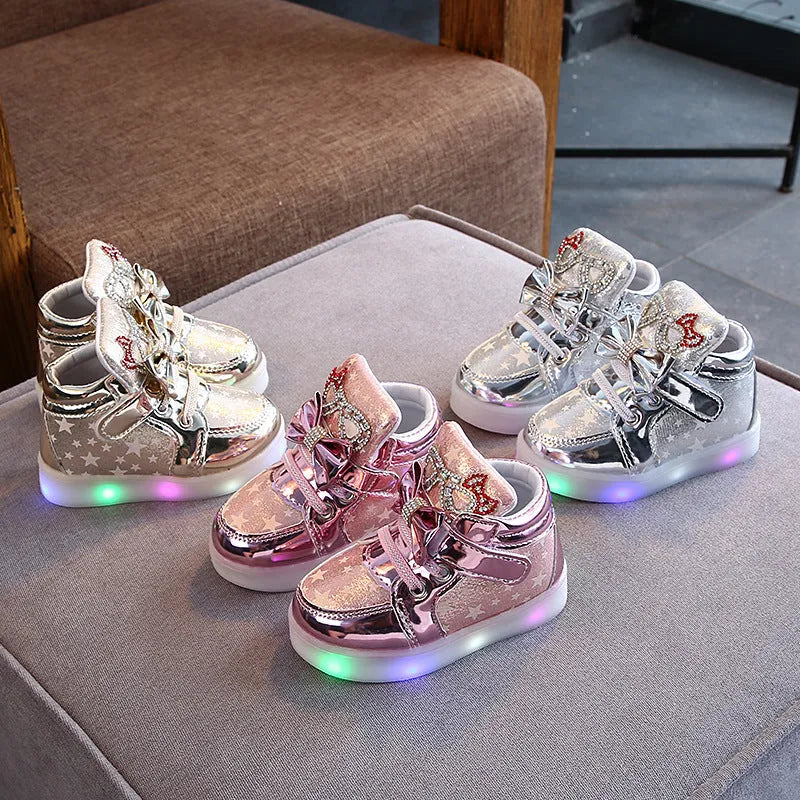 Children's LED light-up trainers with glowing rainbow soles in golden, pink and silvery colours