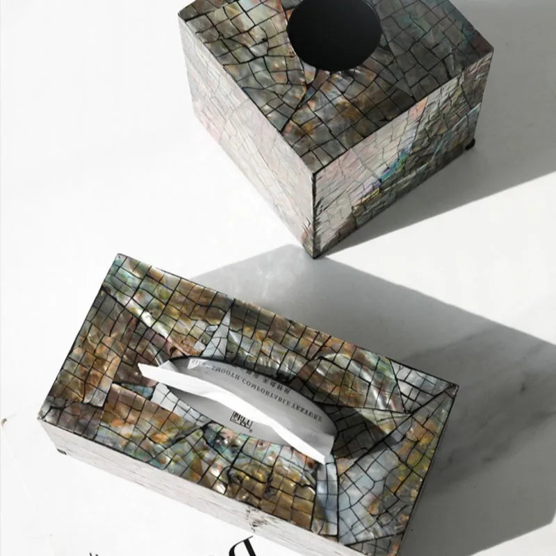 Black rectangular and square natural shell tissue box storage holder on a coffee table.