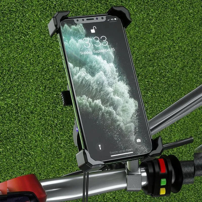 Black plastic motorcycle phone holder with wireless charging and 360-degree rotation mounted on a handlebar