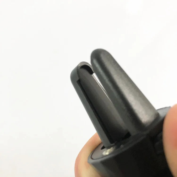 Glory black ABS plastic car phone holder clipped onto a car air vent.