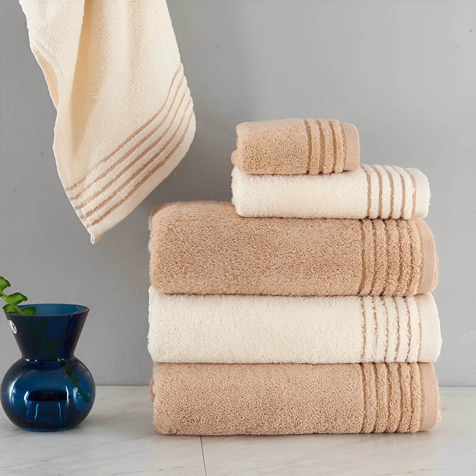 Cotton towel set showing bath, hand and face towels in beige or brown colours