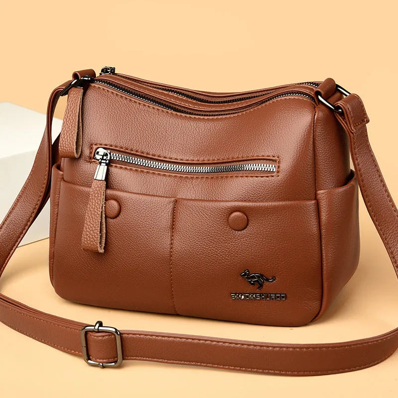 Soft square black PU leather women's crossbody shoulder bag showing front view and open interior with multiple pockets.