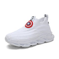 Children's black and white knitted overshoes with sleeve opening for runway or dance performances.