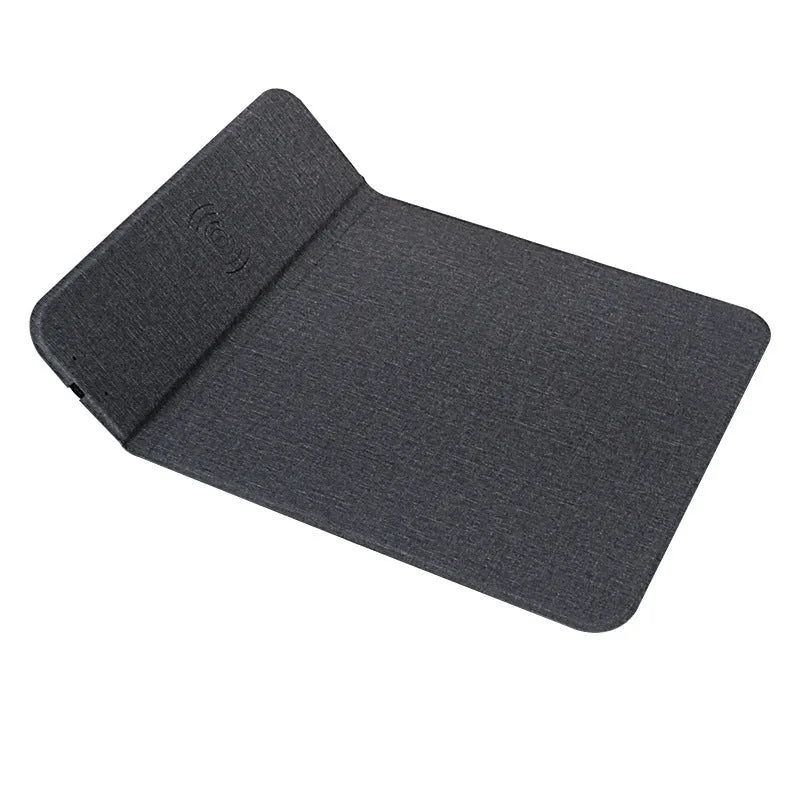 Grey foldable cloth phone holder open in stand mode, wirelessly charging a smartphone.