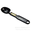 White digital spoon scale with LCD display showing weight measurement for kitchen use