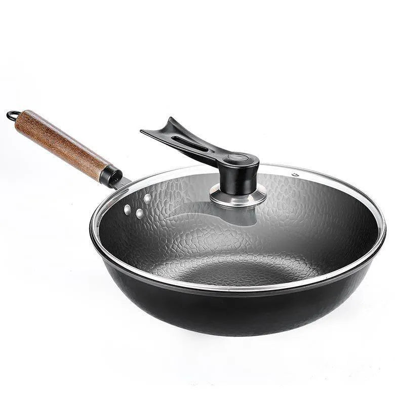 Black 40cm handmade fine iron wok with a long wooden handle on an induction base.