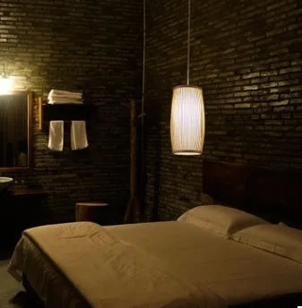 Natural bamboo wall light fixture with a woven shade, measuring 15cm wide and 35cm tall.