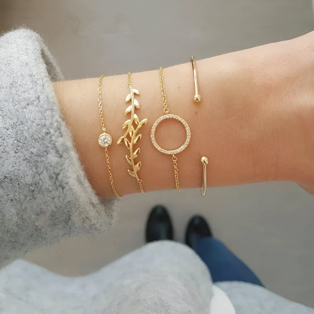 Gold alloy geometric bangle combination set with electroplated finish and about 16cm diameter