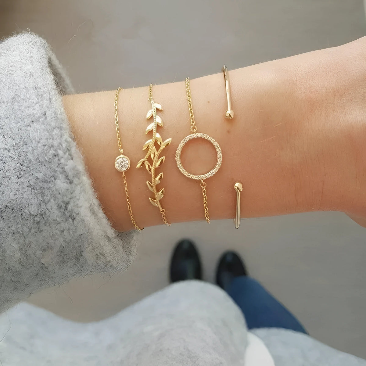 Gold alloy geometric bangle combination set with electroplated finish and about 16cm diameter