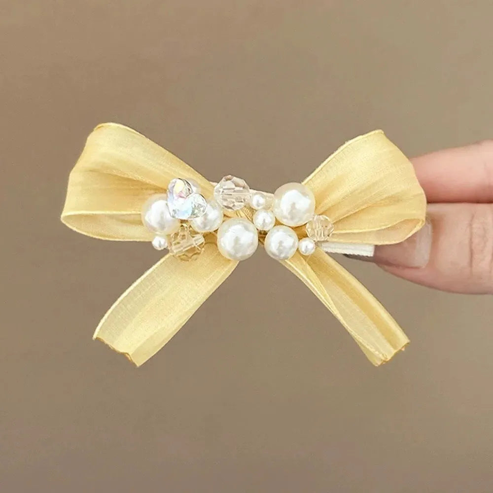 Yellow cloth bow hair barrette with rhinestone and pearl decoration on duckbill clip