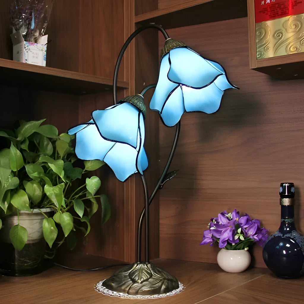 Retro American style table lamp with coloured glass lotus design shade on wooden surface