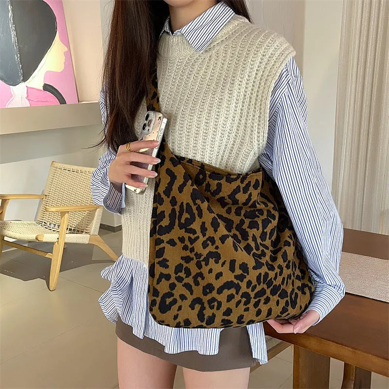 Corduroy leopard print shoulder bag in vertical square shape with open pocket, phone pocket, and document pocket.