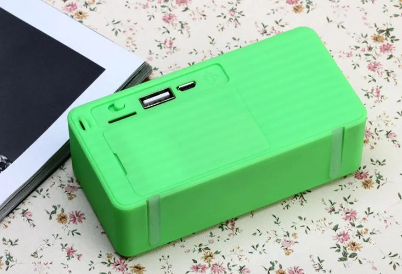 Small cube-shaped Cannon X3 wireless Bluetooth speaker in one of five colours: black, blue, green, red, or yellow.