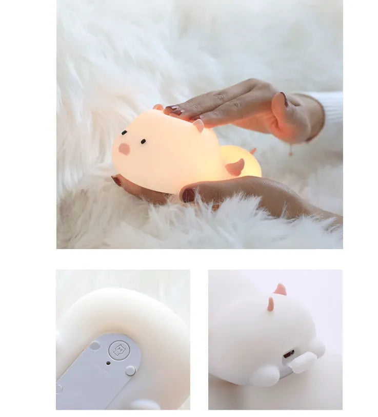 Blue silicone pig-shaped night light with USB charging port