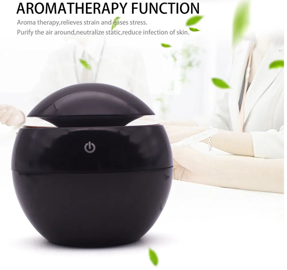 USB ultrasonic atomizer with colourful light and 130ml water tank in white colour option on a wooden desk