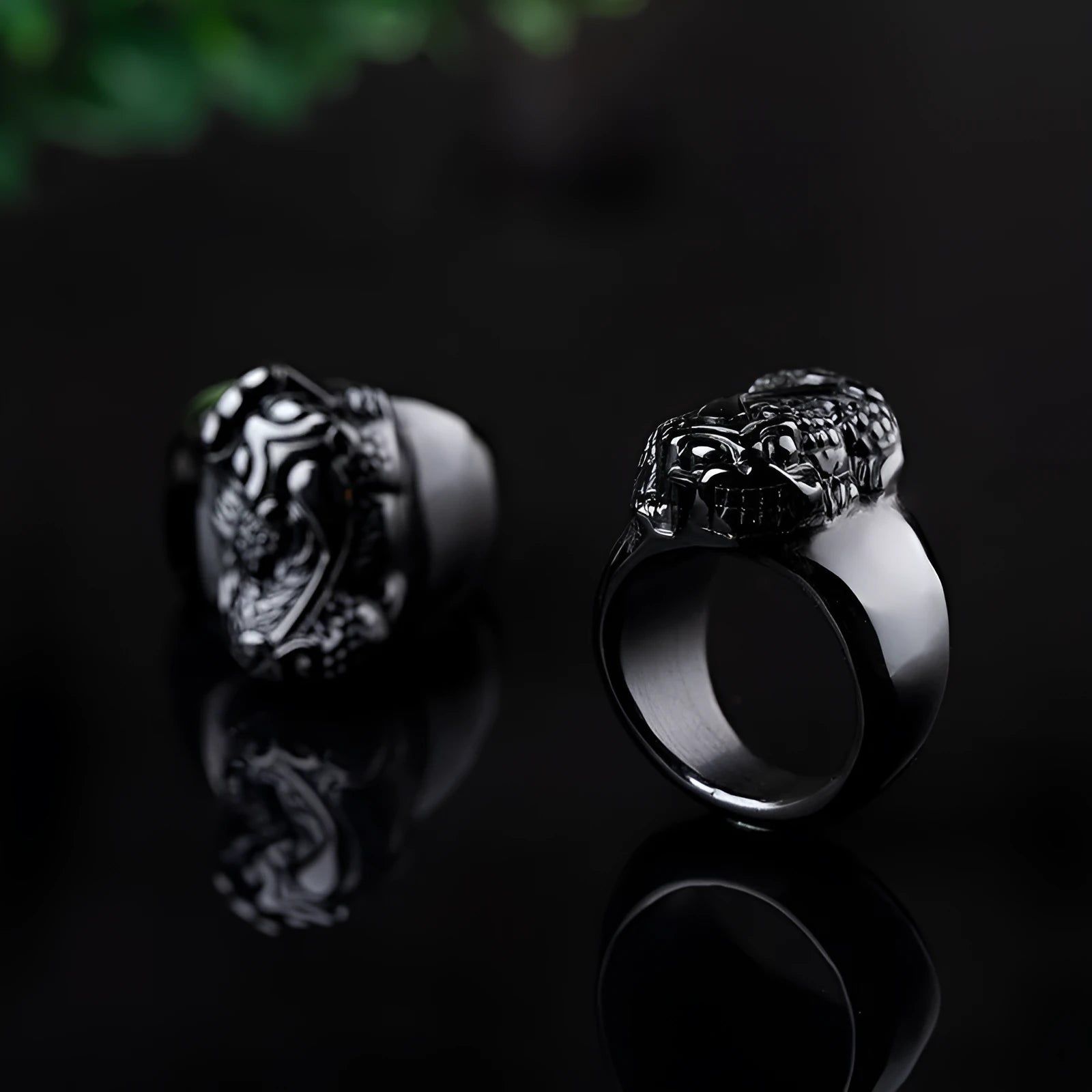 Men's obsidian pixiu thumb ring showing gold sheen and detailed carving on a hand.