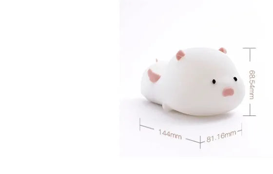Blue silicone pig-shaped night light with USB charging port