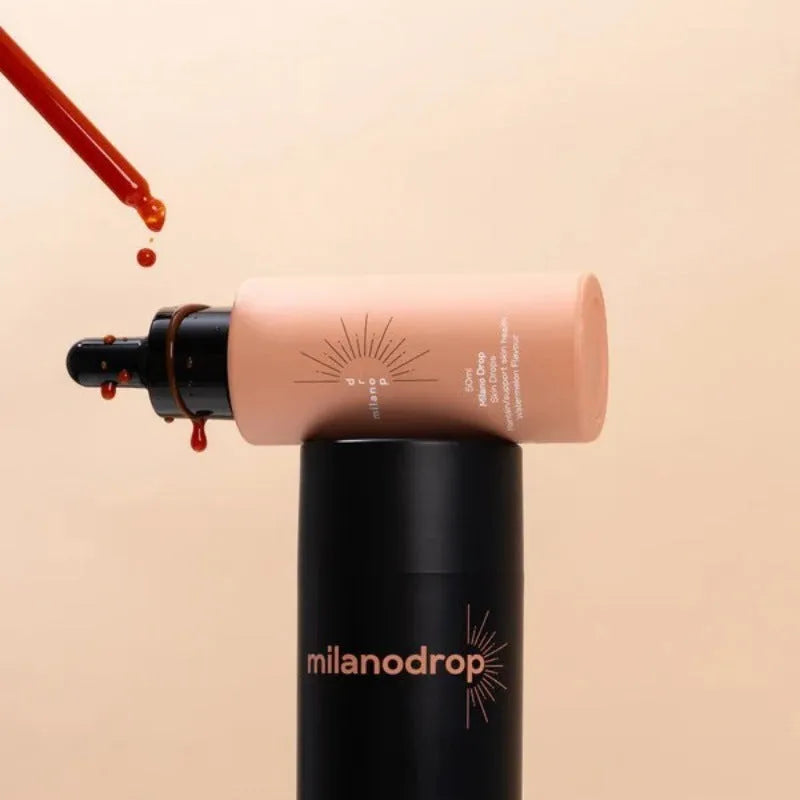 Matte tanning black liquid bottle and glitter cream tube for body care application.