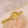 Vintage quartz bracelet watch with diamond-embossed detailing and golden face