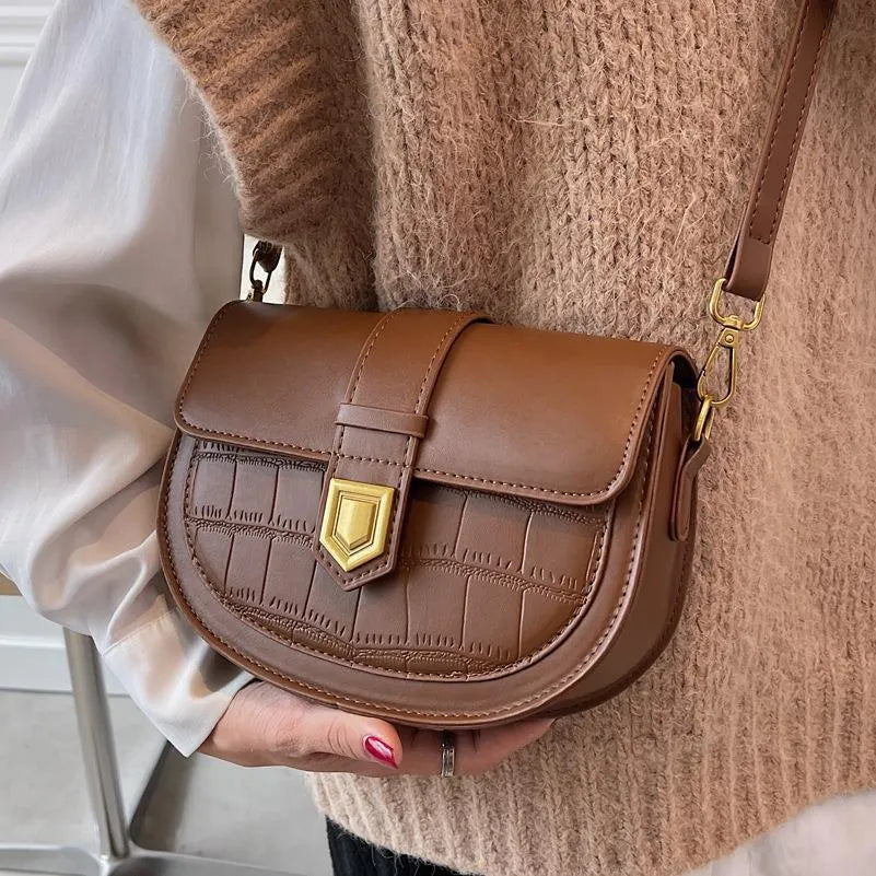 French one shoulder saddle bag for women with lock and stone pattern, available in beige