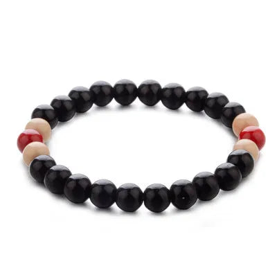Natural stone bead bracelet with lava stones on wrist, showing ethnic unisex design.