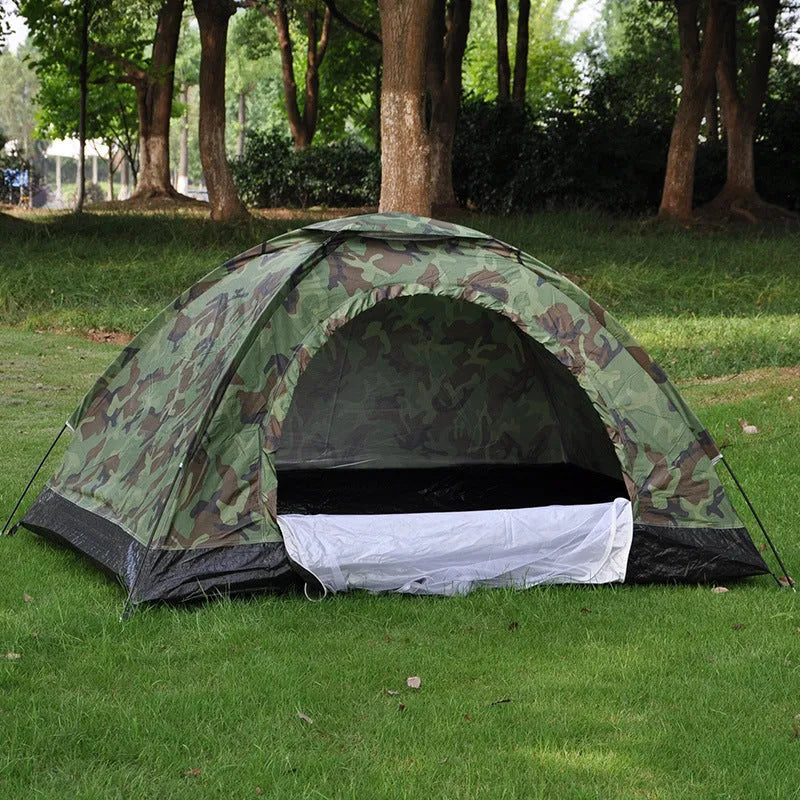 Green camouflage tent with triangular skylight and fibreglass poles set up outdoors