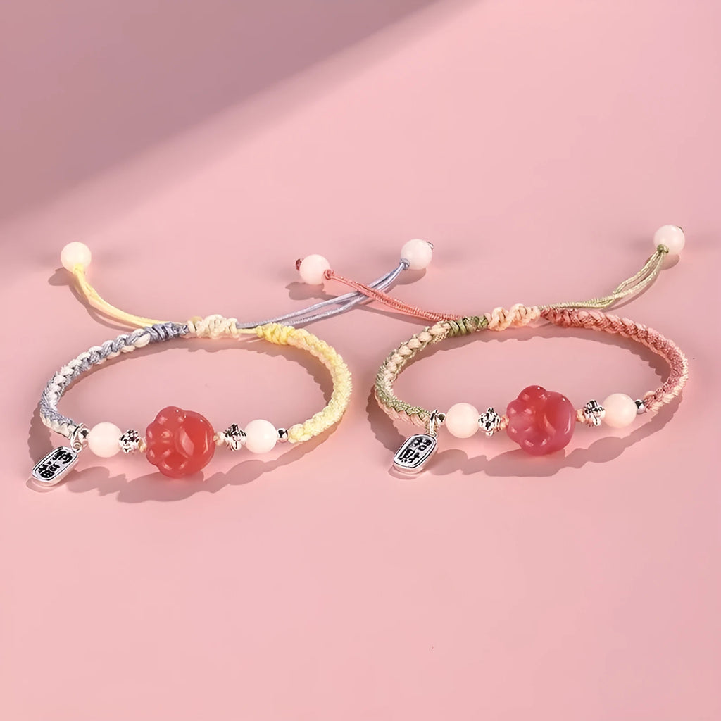 Handmade red cat's paw charm bracelet with pink woven band for couples.