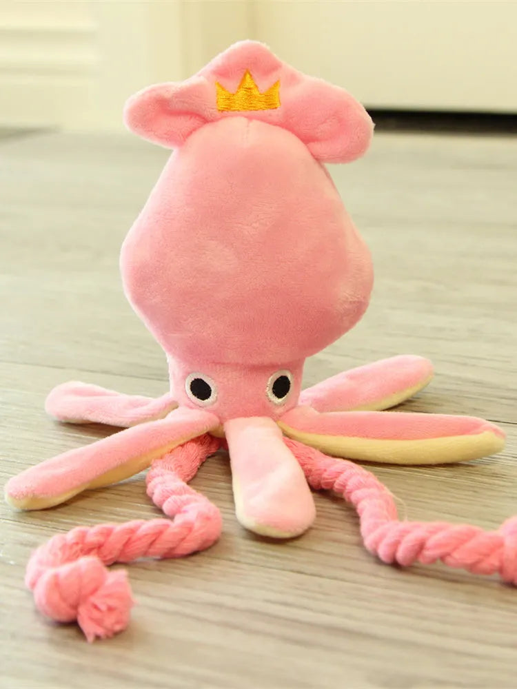 Pink octopus pet plush toy rope toy for dogs with soft fabric head and rope body on white background
