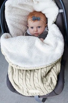 Envelope-style baby stroller sleeping bag in a plain colour, shown on a pram with lamb cashmere lining visible.
